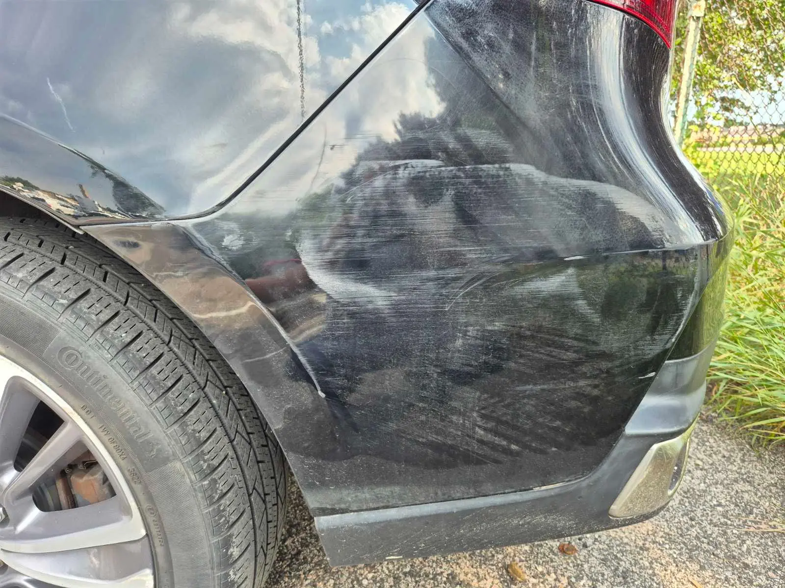 Close view of scuffs on black rear bumper